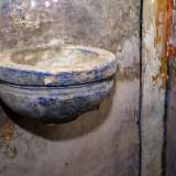 Accanto all�ingresso, sopra un�acquasantiera in pietra...